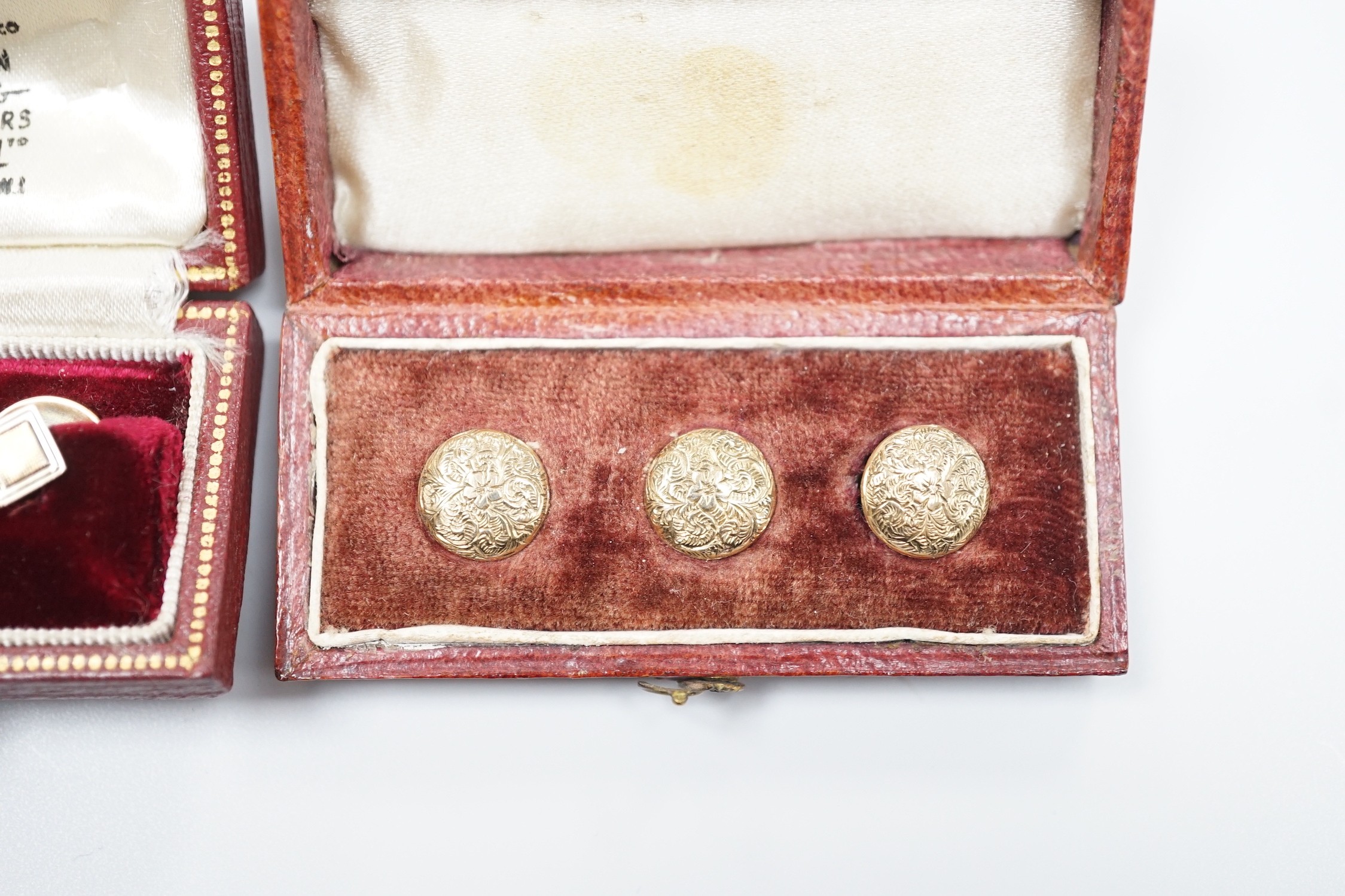 A modern cased pair of 9ct gold dress studs and a cased set of three yellow metal dress studs, gross 4 grams.